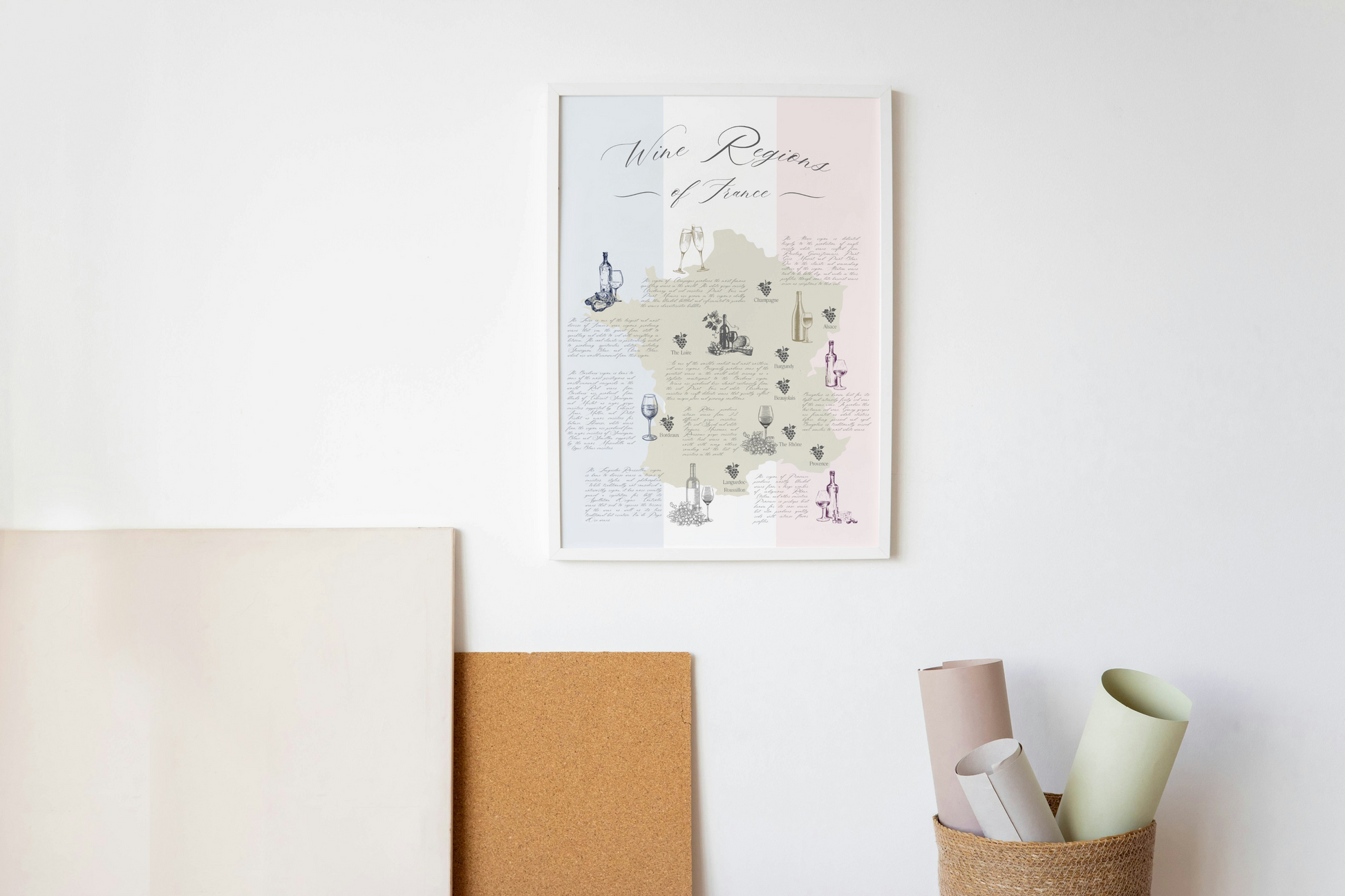 French wine map art print hanging on the wall near neutral colored art supplies.